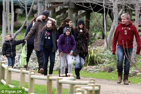 A giraffe meets the Ramsay and Beckham families at the safari park